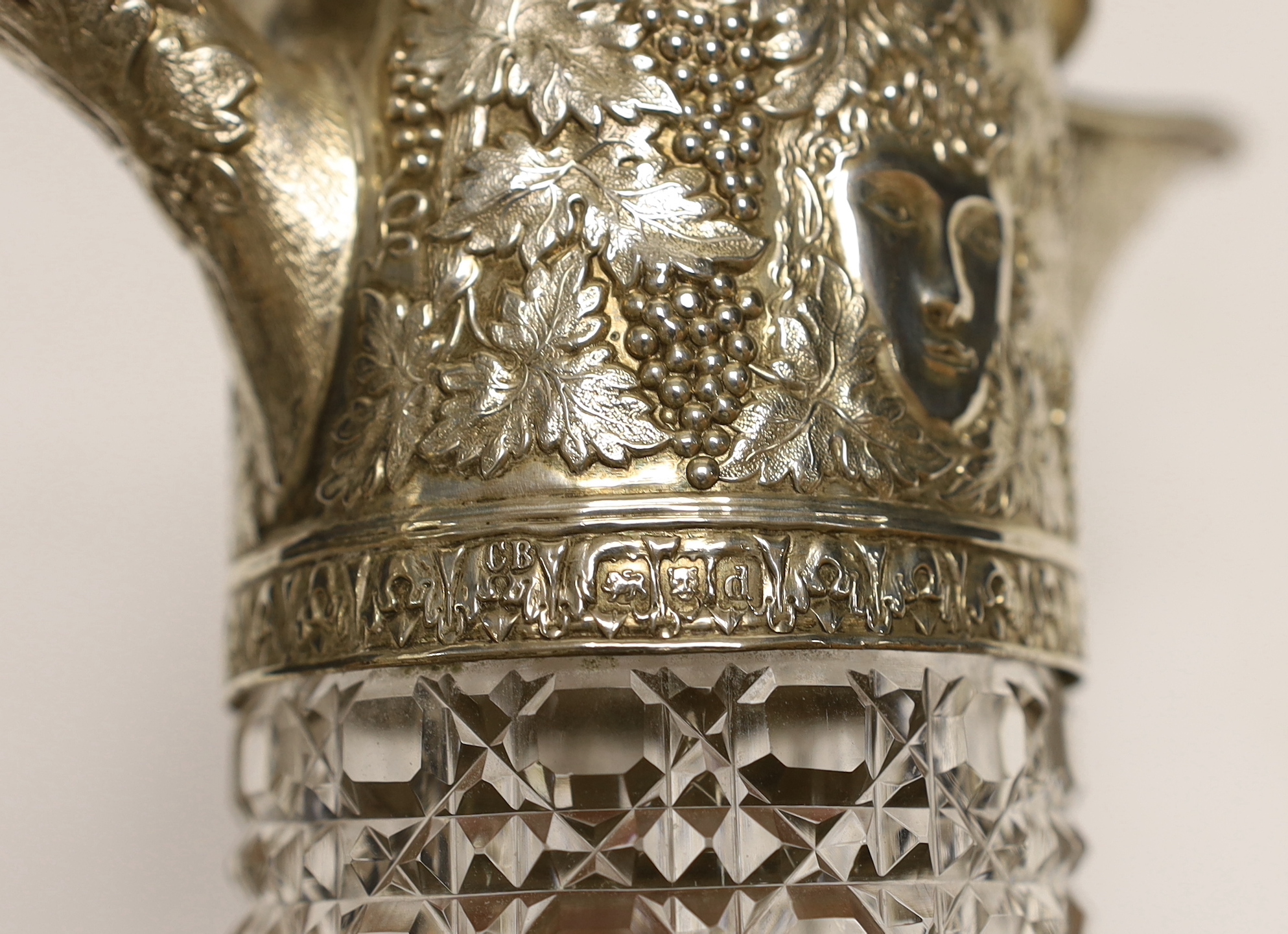 A late Victorian silver mounted cut glass claret jug, by Charles Boyton, London, 1899, the mount with fruiting vine and mask decoration, 27.5cm.